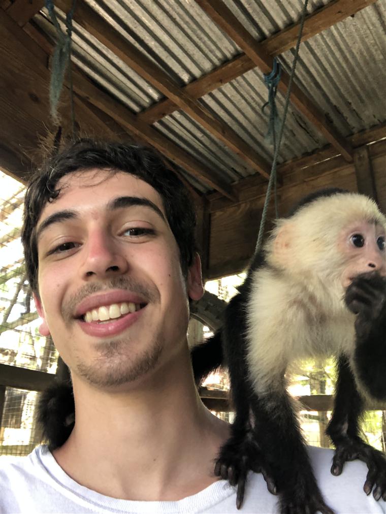 Ezra smiling with a monkey on his shoulder